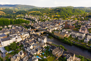 Picturesque drone view of summer cityscape of Espalion on Lot riverbanks overlooking Gothic...