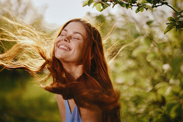 Portrait of a woman with long flyaway hair red hair in summer, the concept of health and care for long thick hair beauty