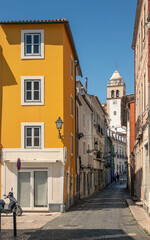 View of Rua da Vitória in the historic center of Leiria with the bell tower in the background.