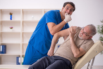 Old male patient visiting young male doctor in vaccination conce