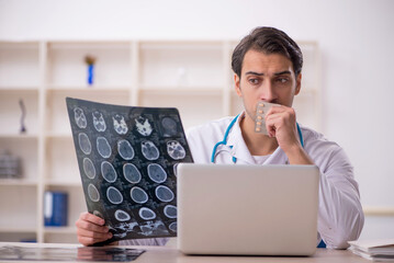 Young male doctor radiologist working in the clinic