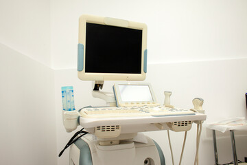 modern ultrasound machine in a hospital on a white background with a blank screen