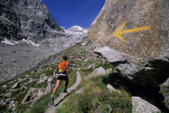 Man trail running in Val De Malatra, Courmayeur, Italy.