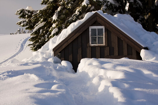 A trail leads through deep snow to the toilet outhouse adjacent to the Elfin Lakes Hut, a large shelter in Garibaldi Provincial