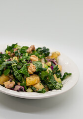 Healthy raw laminate kale salad with walnuts and pear