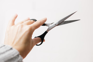 Scissors in the hands of a hairdresser on a white background.