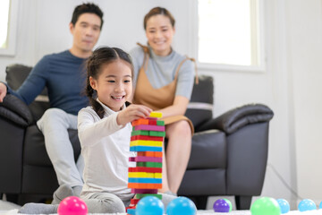 Portrait of enjoy happy love asian family father and mother with little asian girl smiling activity...