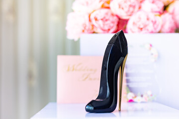 Bride's perfume in a shape of a black shoe close up