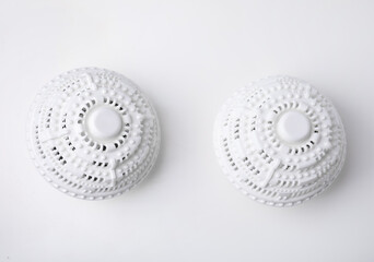 Dryer balls for washing machine on white table, flat lay