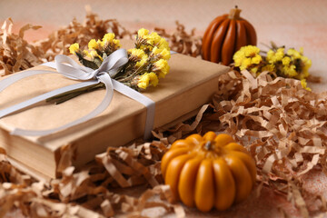 Book decorated with flowers on beige textured table, closeup