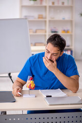 Young male doctor cardiologist working in the clinic