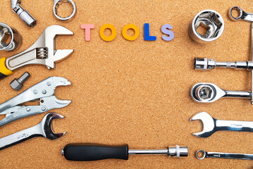 tools next to the letters that say TOOLS on the cork table. View from above.