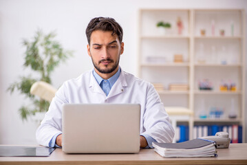 Fototapeta premium Young male doctor in telemedicine concept