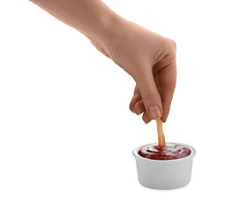 Woman dipping french fry into ketchup on white background, closeup