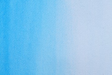 Abstract light blue watercolor painting as background, top view
