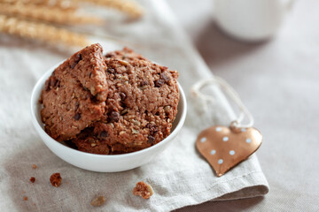 Homemade cookies with cereal and seeds, bowl on a table, made with love