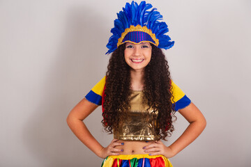 young teen girl, brazilian, with frevo clothes, carnival. wearing feather headdress posing for...