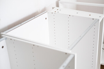 Assembling the white frames of the modular kitchen. Step by step assembly process for a modular...