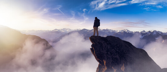 Adventurous Man Hiker standing on top of peak with rocky mountain in background. Adventure Composite. 3d Rendering rocks. Aerial Image of landscape from BC, Canada. Sunset Sky