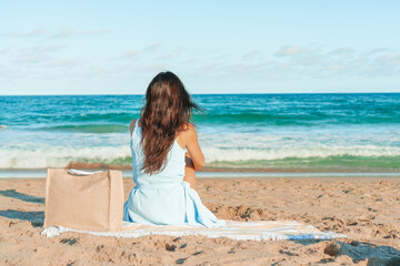 Young beautiful woman on the beach vacation