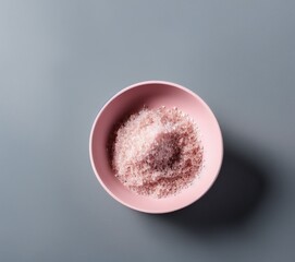 pink salt in a bowl on a white background.