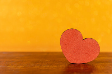 red heart with yellow blur background
