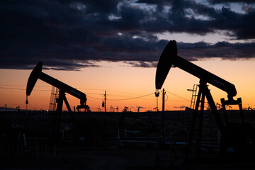 Oil derricks in the sunset in California