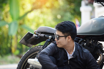 Asian man motorbike in black leather jacket travel rider trip. Handsome Men wear sunglass outdoor lifestyle freedom rider. Men trendy hipster cool person. Young asian man hobby ride with motor bike