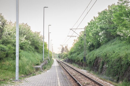 Railway tracks, rails and platforms in a suburban train station in Barajevo in Serbia, electrified, with power overhead line, on a single track main railroad line....