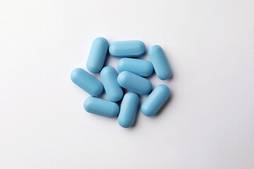 Pills on white background, top view. Potency problem