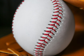 Leather baseball glove with ball, closeup view