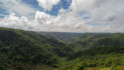 View of a valley with forest and hills near Conques, Aveyron, France