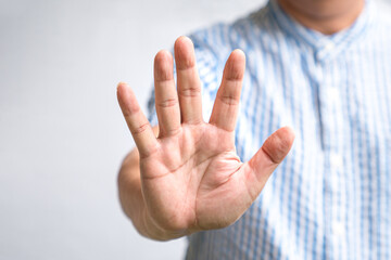 Man showing stop sign gesture with his hand.