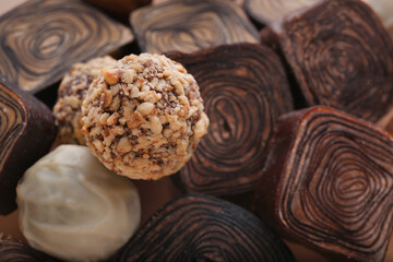 Different tasty chocolate candies as background, closeup