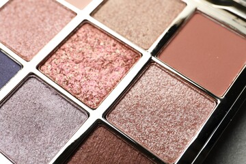 Beautiful eye shadow palette on grey table, closeup