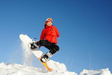 Fototapeta na wymiar Young woman take fun on the snowboard