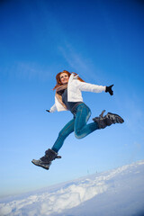 Fototapeta na wymiar Pretty young woman with red hair take a fun on the snow field