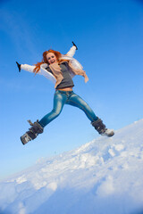 Naklejka na ściany i meble Pretty young woman with red hair take a fun on the snow field