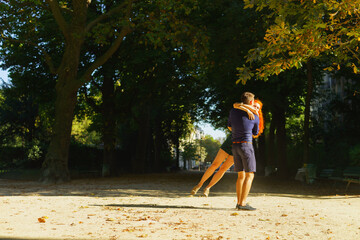 Beauty young couple walking in the park in Paris downtown.