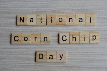 National Corn Chip day text on wooden square, holiday concept quotes