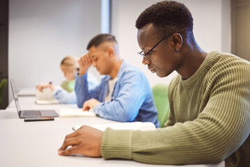 Black man, students and studying for education, knowledge and focus for exams, campus and intelligent. African American male, student and young people on university, concentration and research notes