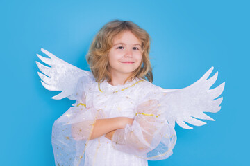 Child at angel costume. Kid with angel wings. Isolated studio shot.