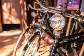 Fototapeta na wymiar Close up on vintage bike headlight with blurry background.