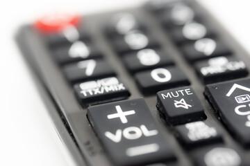TV remote control with focus on volume and mute buttons, concept of deafness