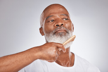 Elderly, black man with comb for beard, beauty and grooming with hygiene and cosmetic care against studio background. Hair care mockup, brush body hair and face with hair treatment and cosmetics - obrazy, fototapety, plakaty