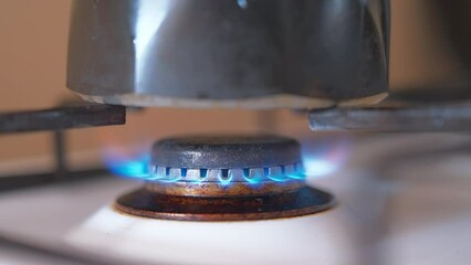 Geyser in the kitchen, the coffee pot is put on the stove, coffee is brewed. Video 4k in real time. Energy crisis, environmental issues and natural resources. - Powered by Adobe