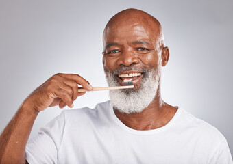 Brushing teeth, studio portrait and black man with toothbrush for mature dental wellness, healthy lifestyle or cleaning aesthetic in Nigeria. Happy face, male model and oral mouth care of fresh smile