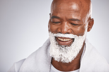 Face, shaving cream and happy black man with smile on beard, skincare treatment on grey background. Health, mock up and facial hair, mature man morning shave routine with space for product placement.