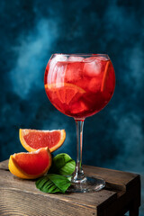 Glass of fresh summer cocktail on colorful backgtound