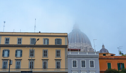 Dome of the church, basilica in the mist. Buildings, tenements, windows, shutters, blue sky.